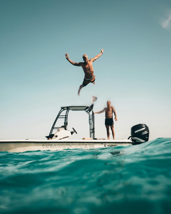 man jumping off boat