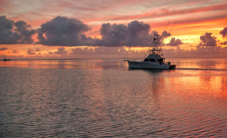 fishing charter boat at sunset